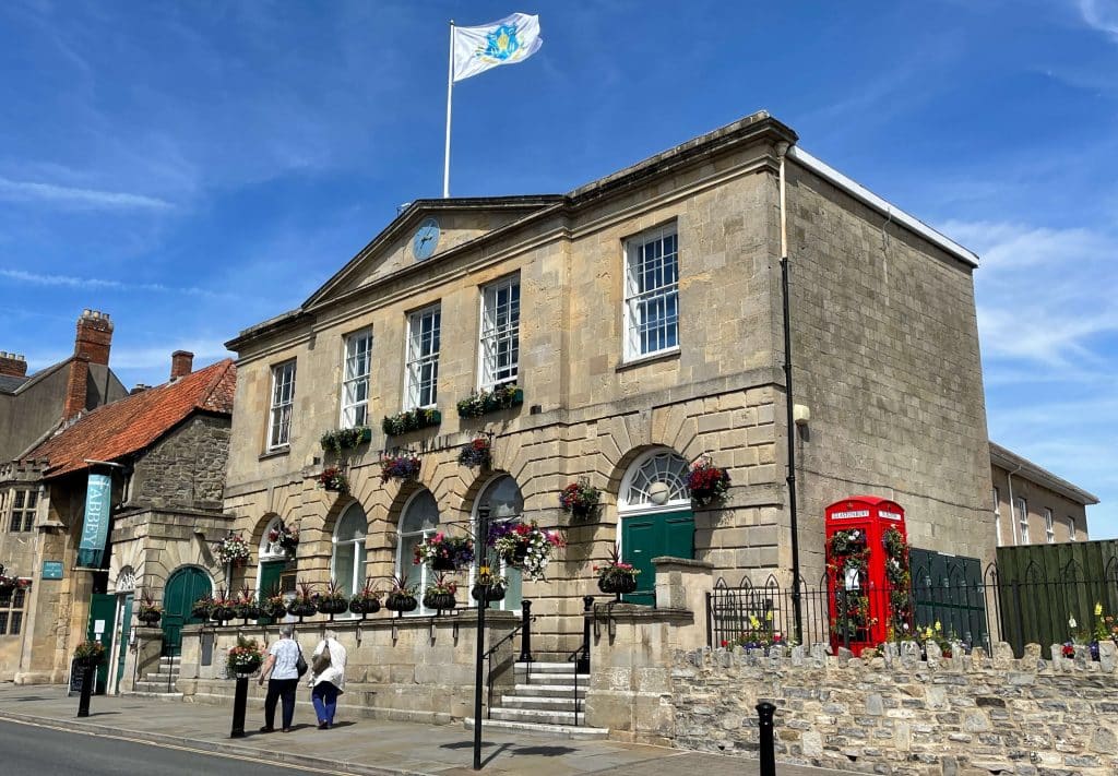 An image of Glastonbury Town Hall, flying the Glastonbury Town Council flag