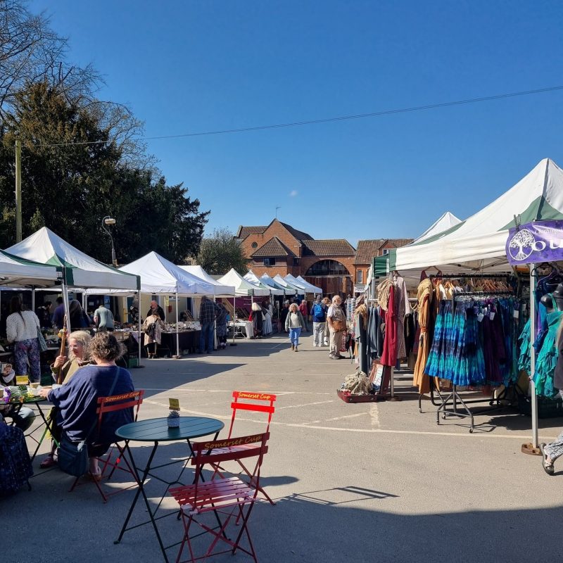 Glastonbury Tuesday Market in the sunshine with blue skies