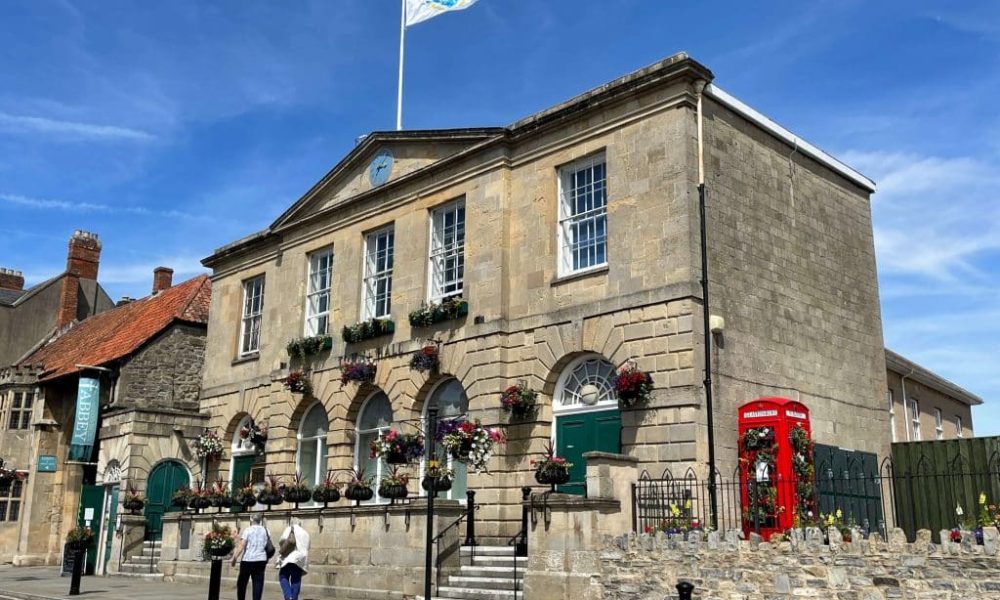 An image of Glastonbury Town Hall, flying the Glastonbury Town Council flag
