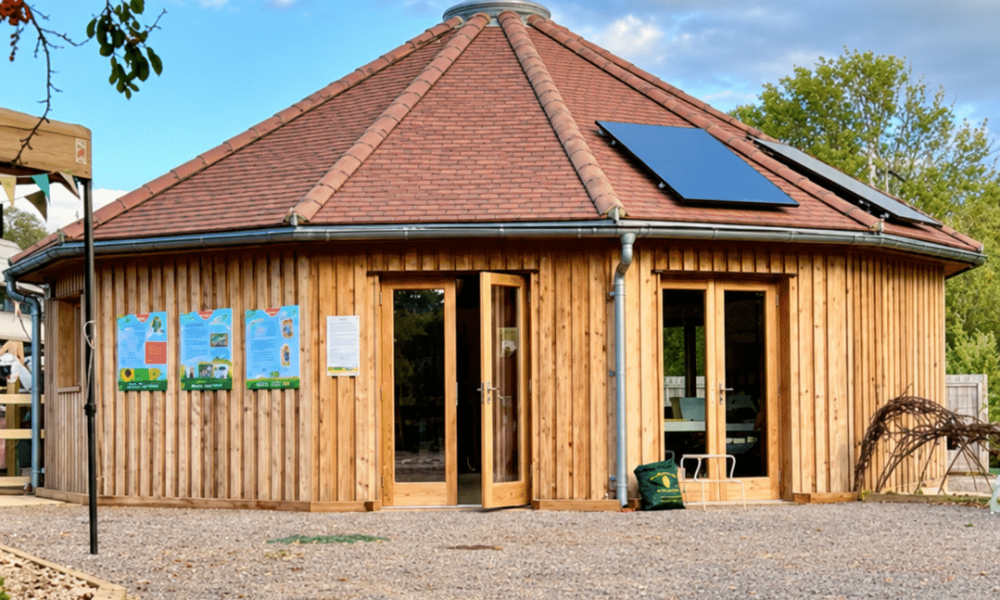 Wooden roundhouse beneath a leafy arch-2